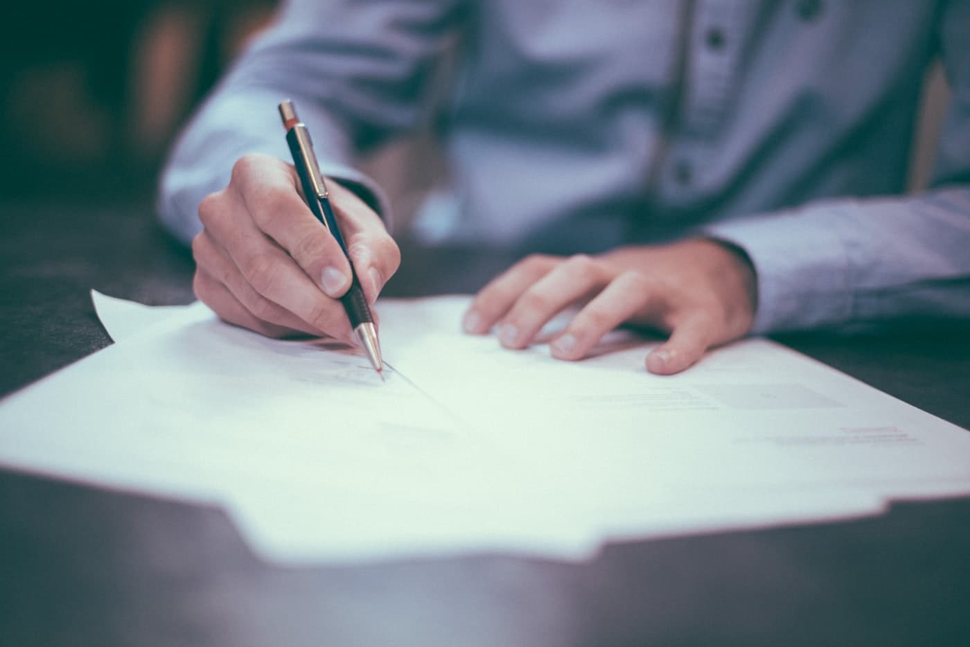 Bookkeeper reviewing accounts and financial reports at a desk